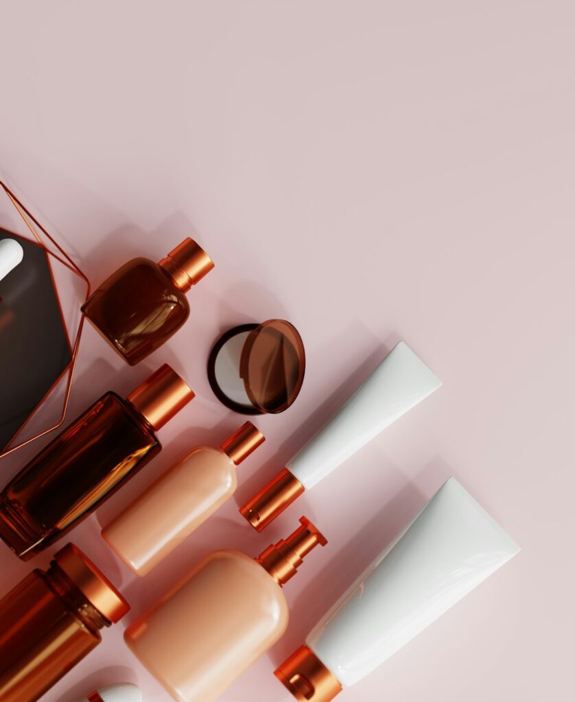 Skincare bottles in a warm neutral studio setting